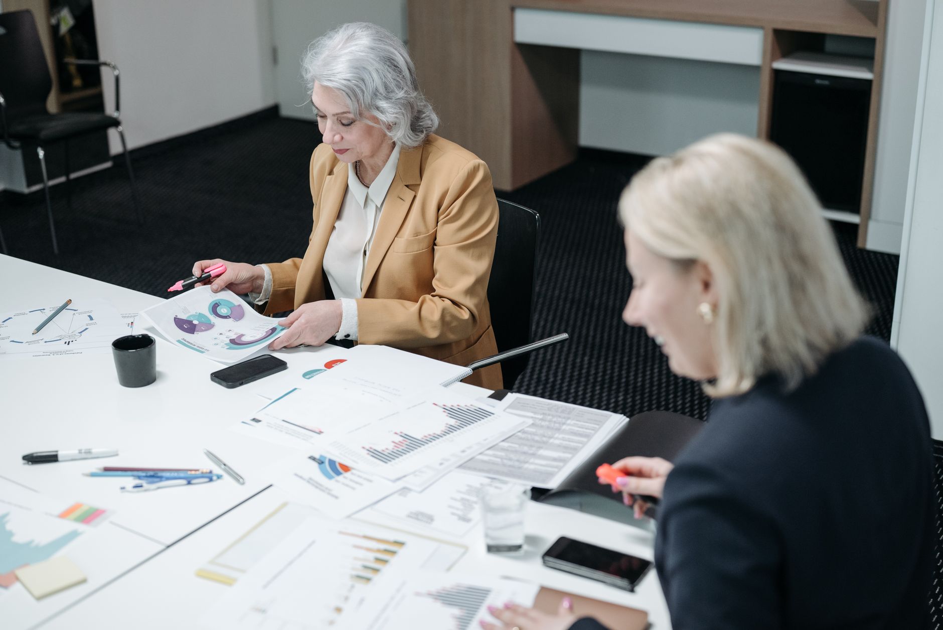 People reviewing papers around a meeting table